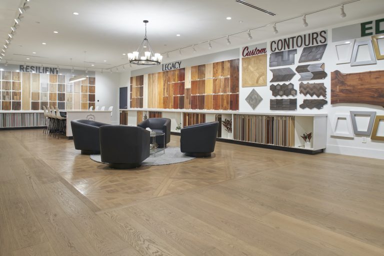 The Garrison Van Nuys showroom with flooring samples on the walls and a beautiful custom wooden floor