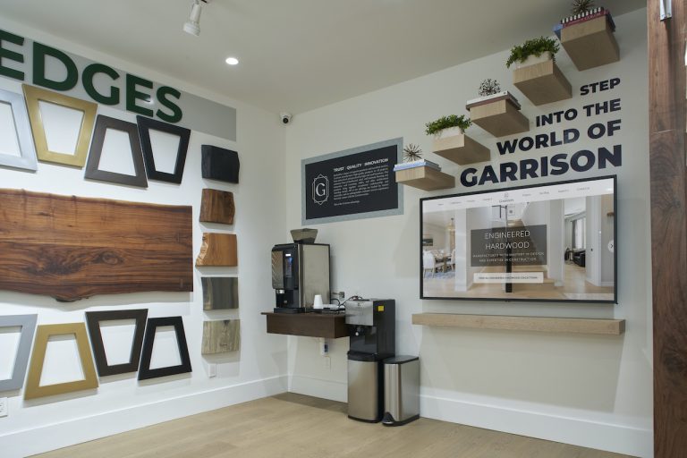 The Garrison Van Nuys showroom with flooring samples on the walls and a beautiful custom wooden floor