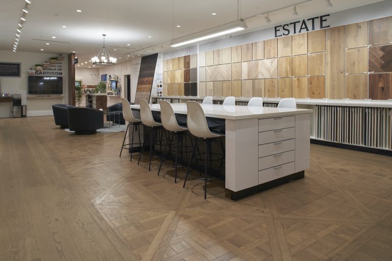 The Garrison Van Nuys showroom with flooring samples on the walls and a beautiful custom wooden floor