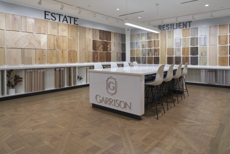 The Garrison Van Nuys showroom with flooring samples on the walls and a beautiful custom wooden floor