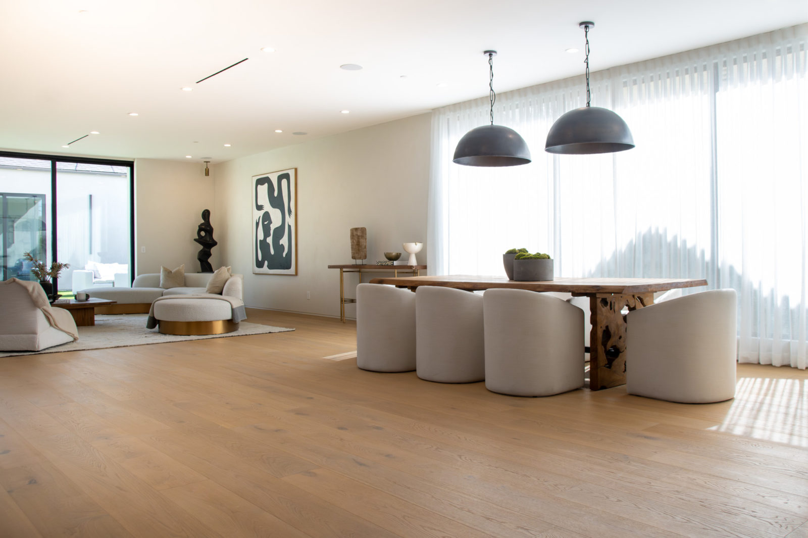Wide plank hardwood flooring creating a spacious modern home design